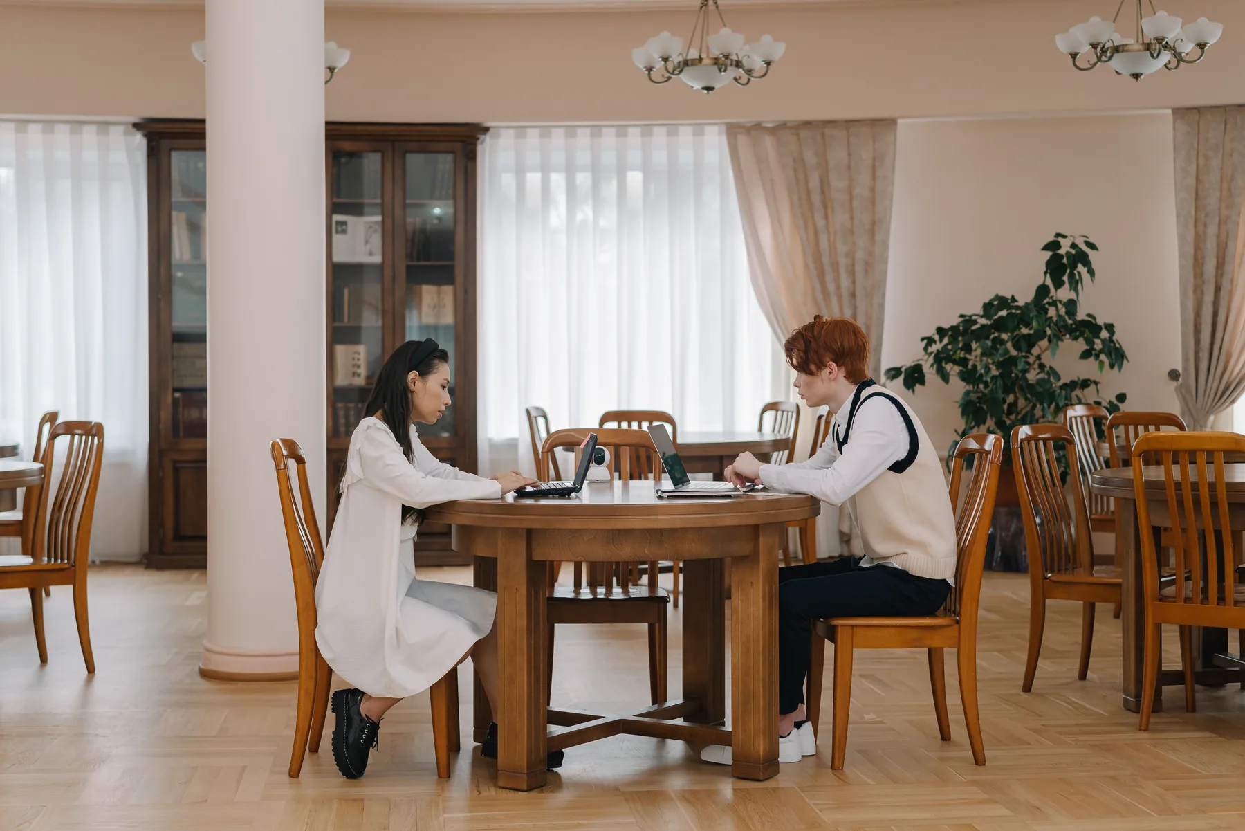Two students studying in a quiet library